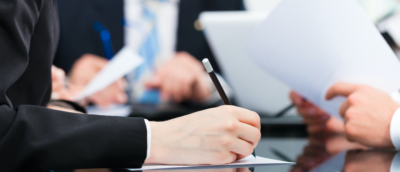 Business - meeting in an office, lawyers or attorneys discussing a document or contract agreement